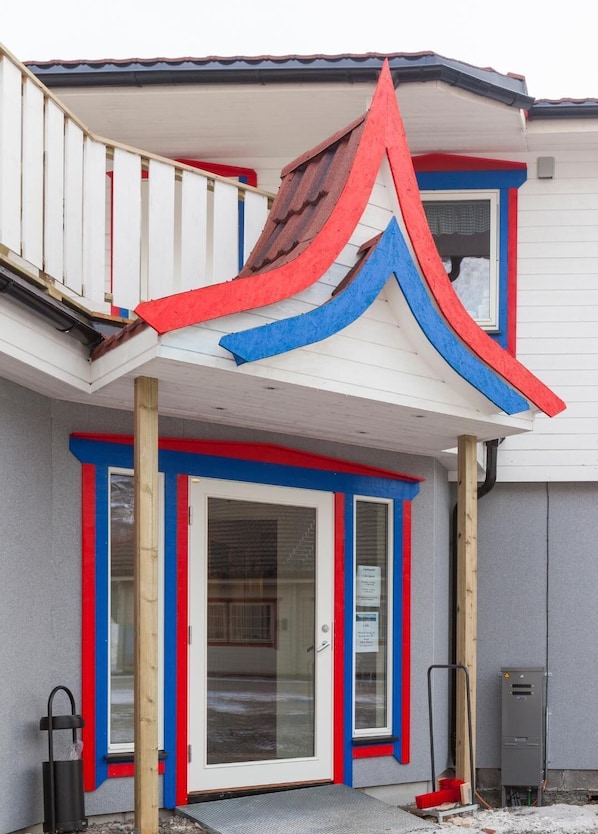 A house with a balcony, a front door, and a window. - Håkon Gjestehus (Kåfjord)