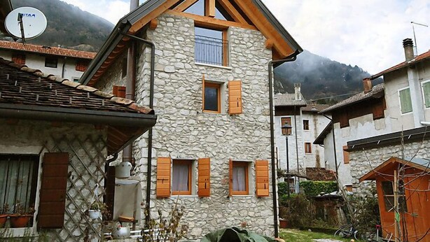 A stone building with wooden shutters, a satellite dish, and a chimney. - Albergo Diffuso - Cjasa de Barce by Interhome (Barcis Lake)