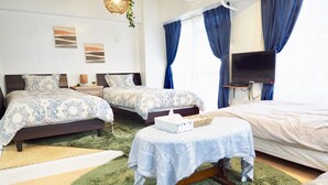 A bedroom with two beds, a TV, and a small table with a tissue box. - Holiday Homes TSUBOYA 4th (Naha)