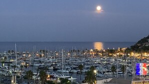 A marina at dusk with boats docked and a moon in the sky. - Le Grand Pavois by Interhome (Cavalaire)