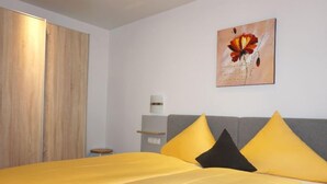 Ein Hotelzimmer mit einem Bett, einem Nachttisch, einer Wandlampe und einem Gemälde.