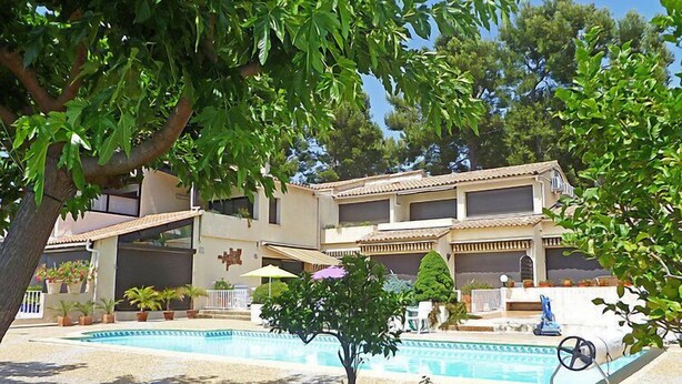 A two-story building with a swimming pool, surrounded by greenery and potted plants. - La Madrague d'Azur by Interhome (Saint Cyr sur Mer La Madrague)