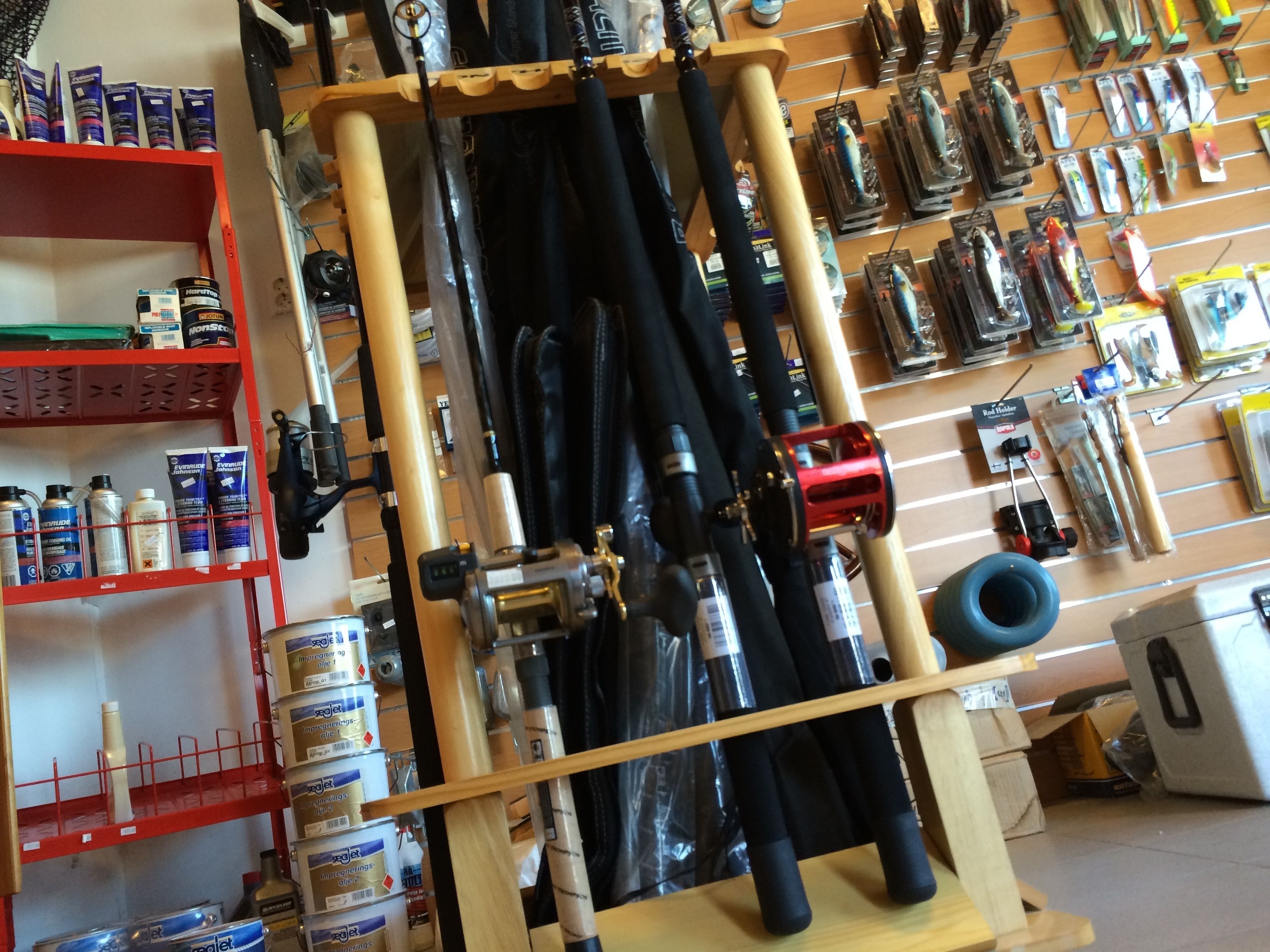 A fishing tackle shop with shelves stocked with fishing rods, reels, and bait.