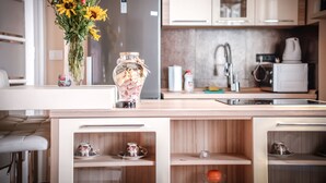 A modern kitchen with a built-in island, a refrigerator, a sink, and a microwave.