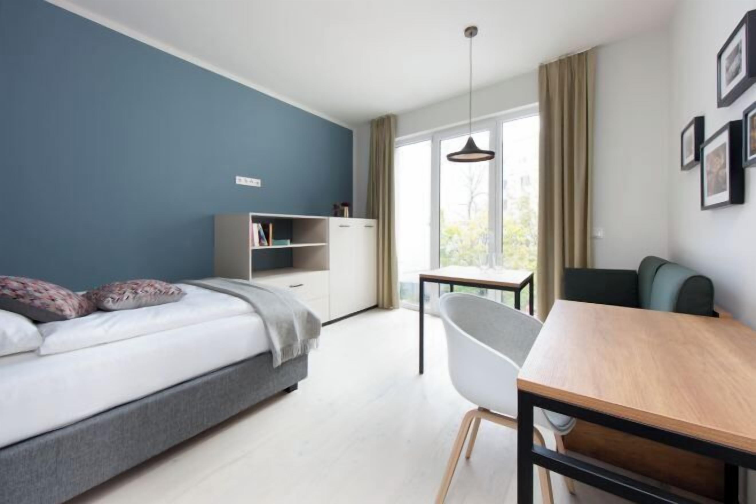 Hypo-allergenic bedding, desk, laptop workspace, blackout drapes