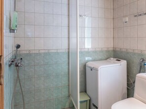 A bathroom with a shower, toilet, and a small step stool. - Noukatti by Interhome (Sotkamo)