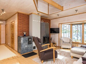A cozy living room with a fireplace, a television, and a comfortable seating area.