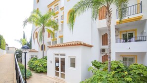 A multi-story building with balconies, a gated entrance, and surrounding greenery. - Altea Dorada by Interhome (Altea)