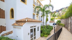 A white building with a tiled roof, a small entrance, and a balcony with a railing. - Altea Dorada by Interhome (Altea)