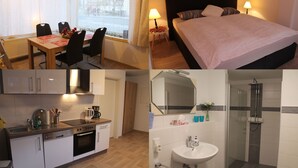 Une chambre d’hôtel comprenant un lit, une table à manger avec des chaises, une cuisine équipée et une salle de bain avec douche.