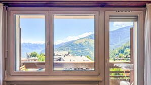 A room with a view of a mountainous landscape through large windows. - Valaisia 35A by Interhome (Nendaz)