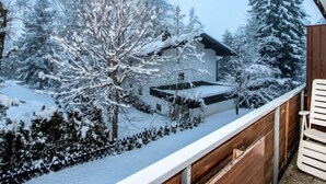 A modern house with a wooden deck, surrounded by snow-covered trees and a clear sky. - Am Birkenhain by Interhome (Seefeld in Tirol)