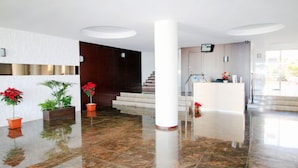 A spacious lobby with a marble floor, a reception desk, and a staircase leading to upper floors. - Torre Principado by Interhome (Benidorm)