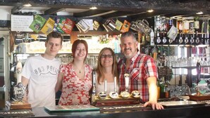 A bar with a counter displaying various bottles and a sign about tobacco sales.