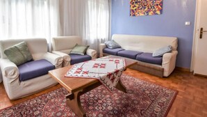 A living room with two sofas, a coffee table, and a patterned rug. - La Busa by Interhome (Alleghe)