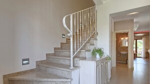A staircase with a white railing leading to a landing with a potted plant. - Vacation home Angela by Interhome (Poreč/Sv. Lovreč)