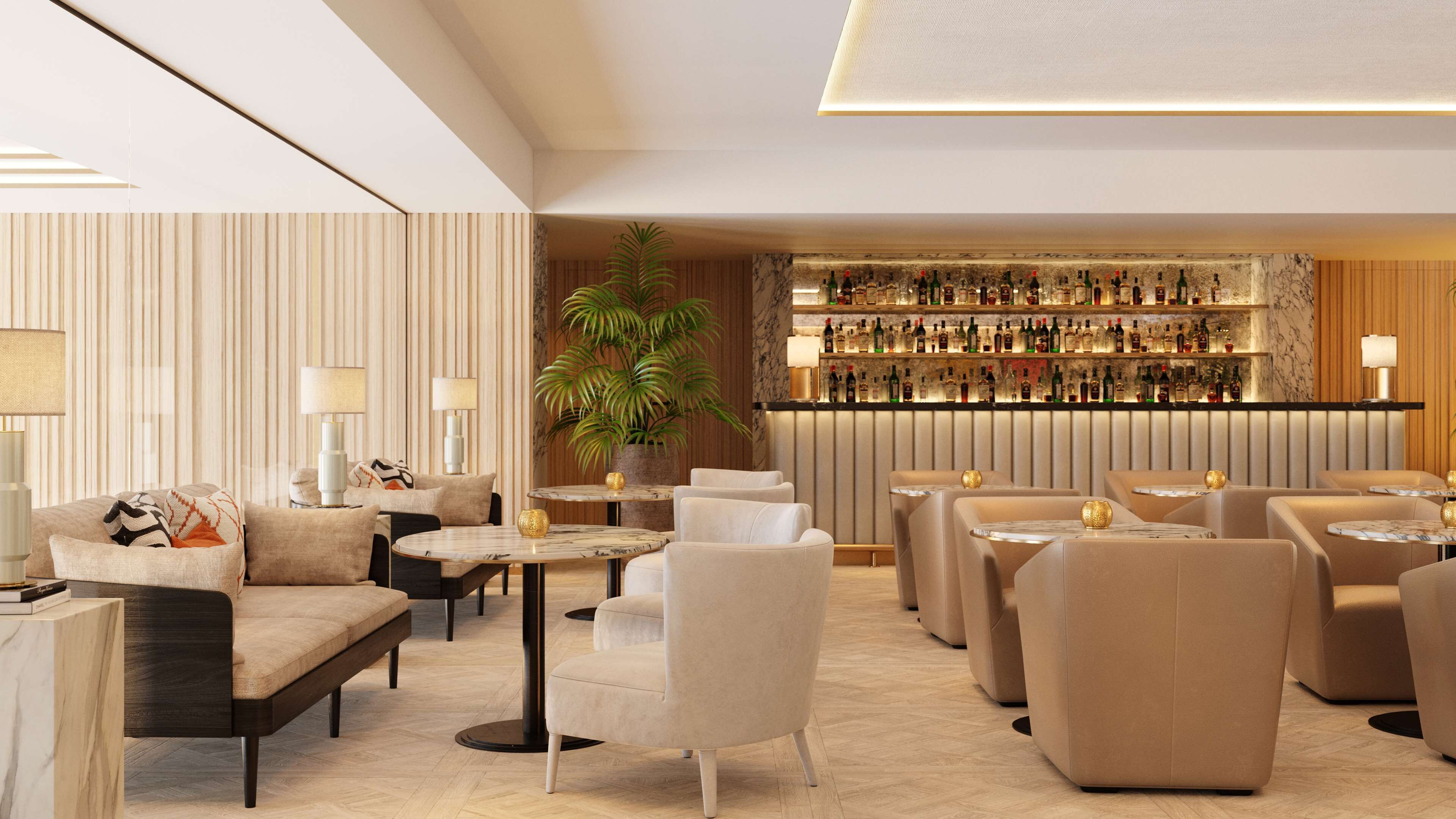 A modern lounge area with sofas, armchairs, and tables, featuring a bar with a variety of bottles.