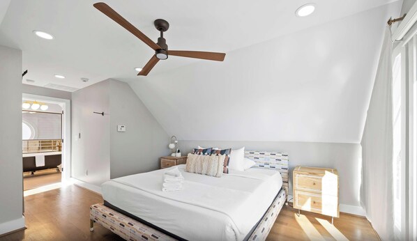 A bedroom with a bed, a nightstand, a wooden dresser, a ceiling fan, and a window with curtains. - 1BR, Next to Monastery Wedding Venue, w/Bathtub (Cincinnati)