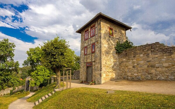 A stone building with a small entrance and a pathway leading to it.