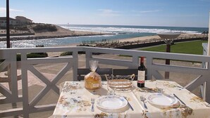 A table set for two with a view of the ocean and beach. - Grand Pavois by Interhome (Mimizan)