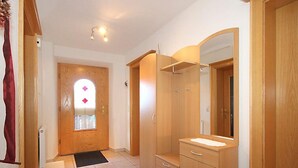 A bathroom with wooden cabinets, a sink, and a mirror. - Lueg ins Land by Interhome (Reith bei Seefeld)