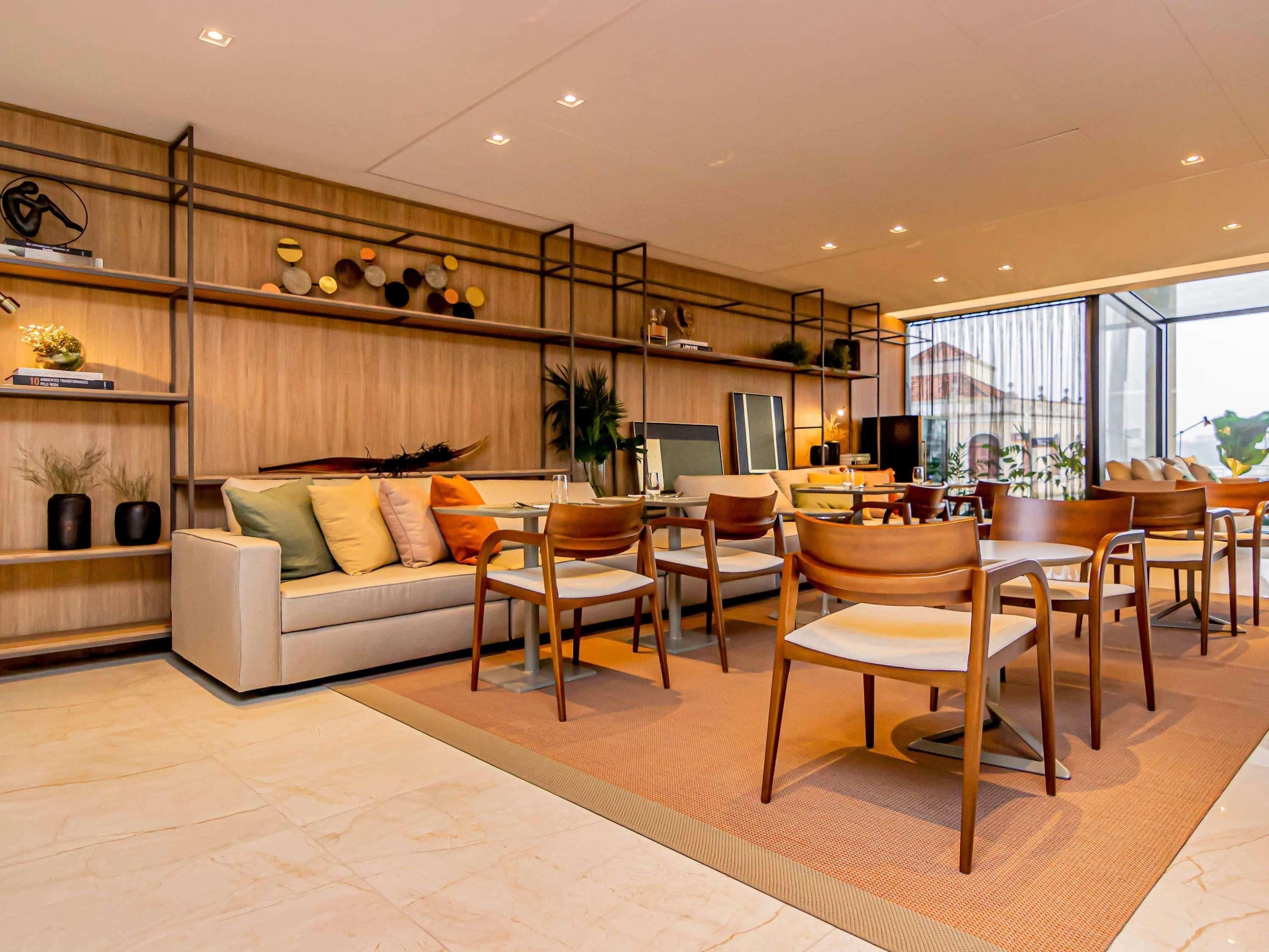 A modern interior with a sofa, chairs, a coffee table, and a TV.