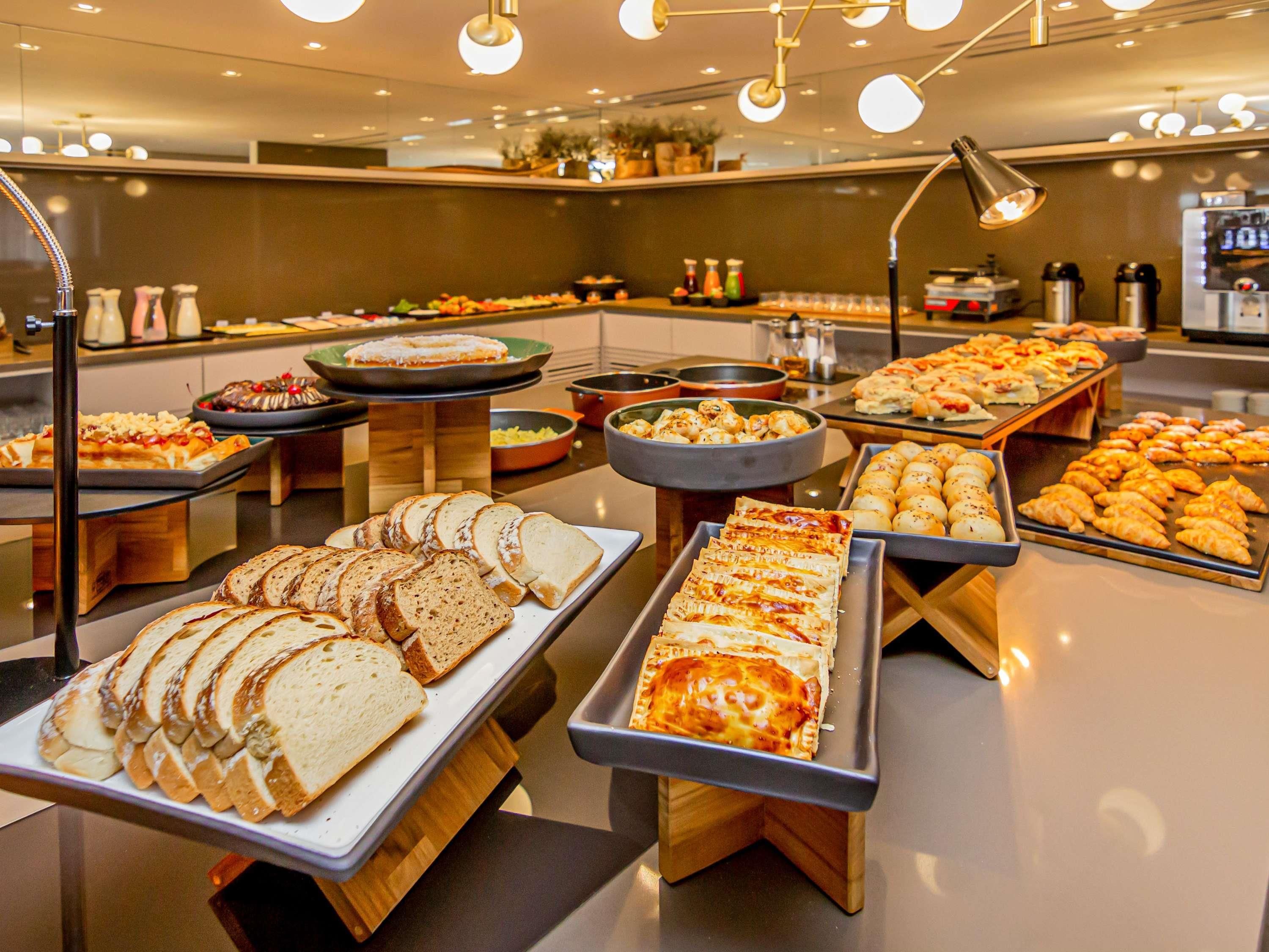 A buffet with various food items and a coffee machine.