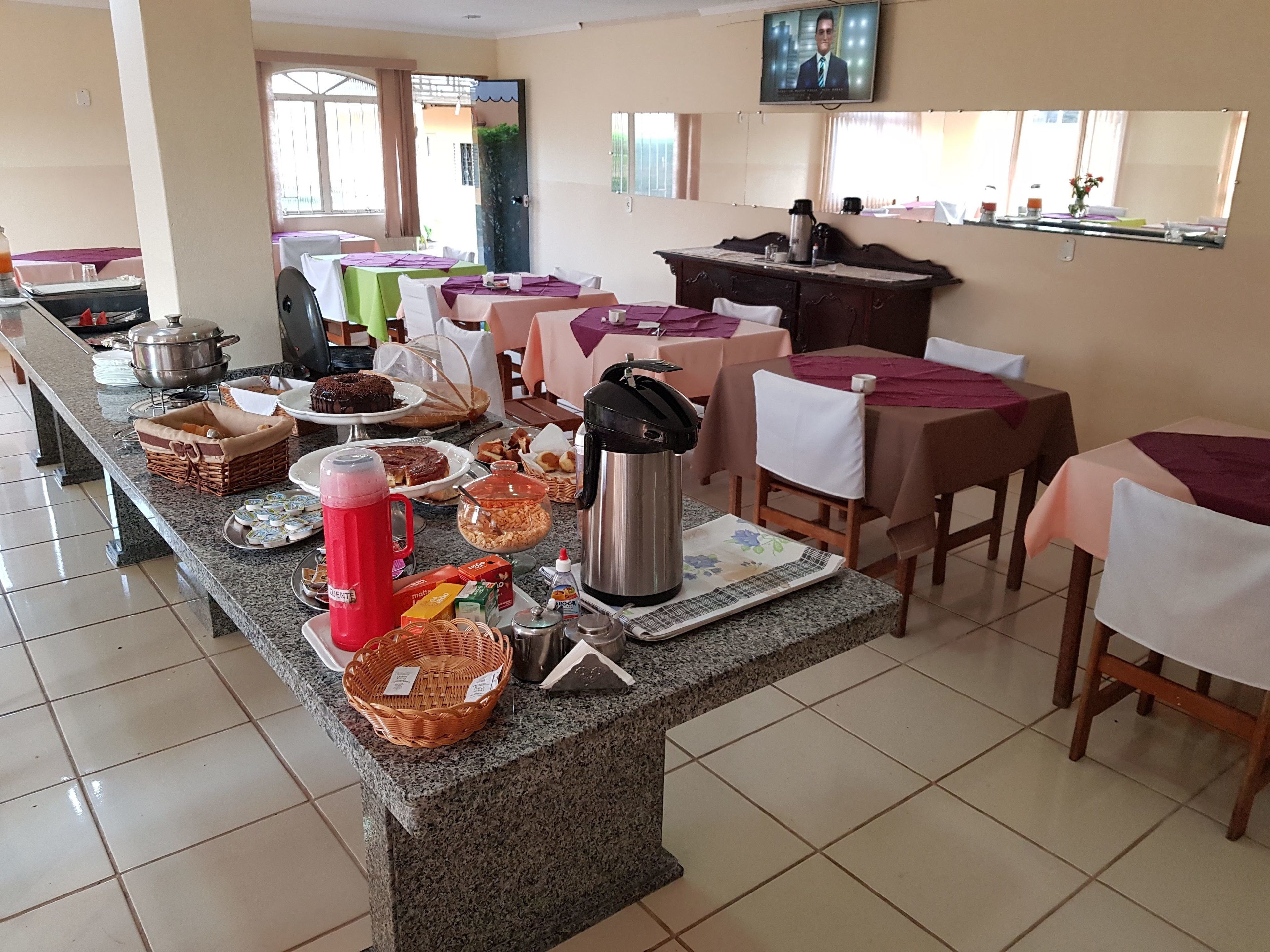 A buffet setup with various food items and a coffee station.