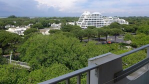 A modern building with a unique dome-like structure surrounded by lush greenery. - du Parc II by Interhome (La Grande Motte)