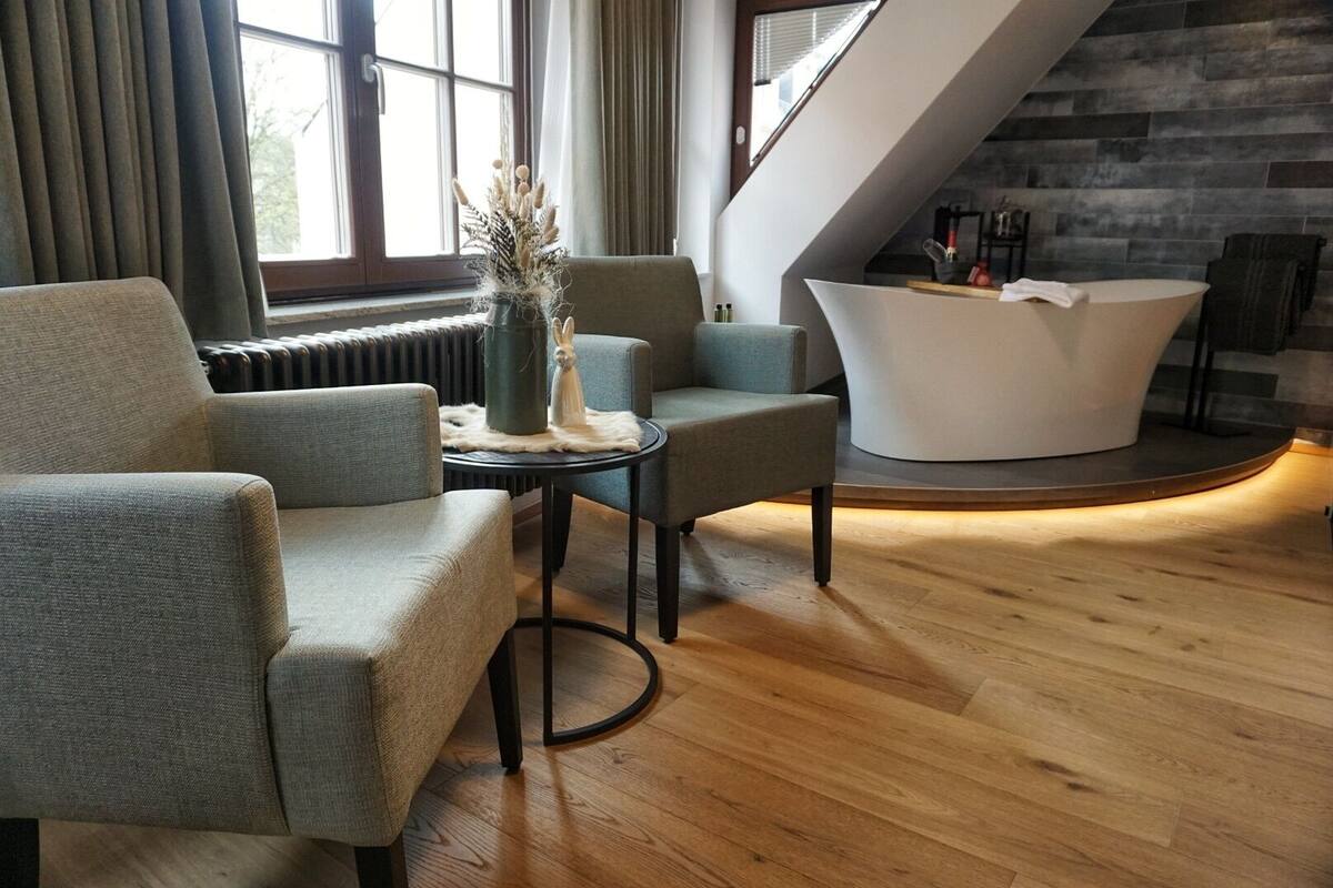 A modern interior with a reception desk, seating area, and a stone wall.