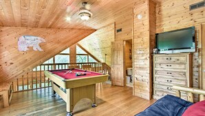 A wooden interior with a pool table, a television, and a bunk bed. - Cabin w/ Hot Tub & Deck ~ 7 Mi to Pigeon Forge! (Sevierville)