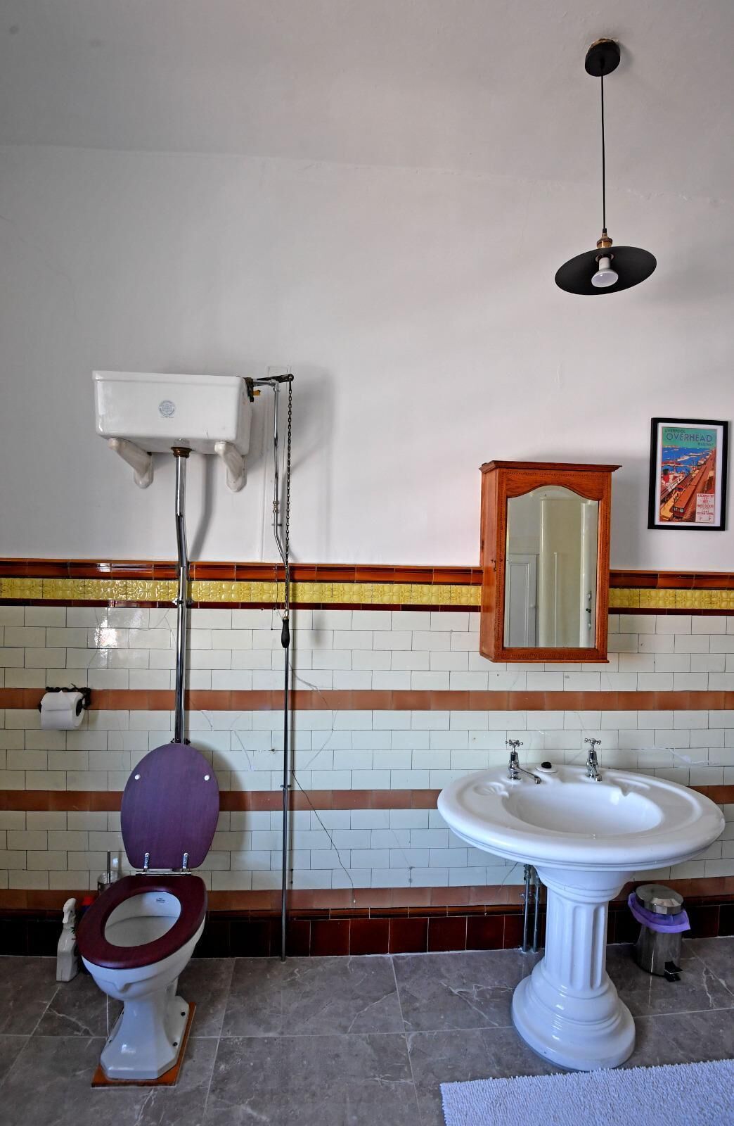 A bathroom with a toilet, bidet, sink, and a mirror.