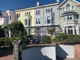 A row of colorful Victorian-style houses with bay windows and ornate detailing.