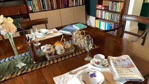 A dining table set with a book, a newspaper, and a tray of food and drinks. - Aberley House (Liverpool)