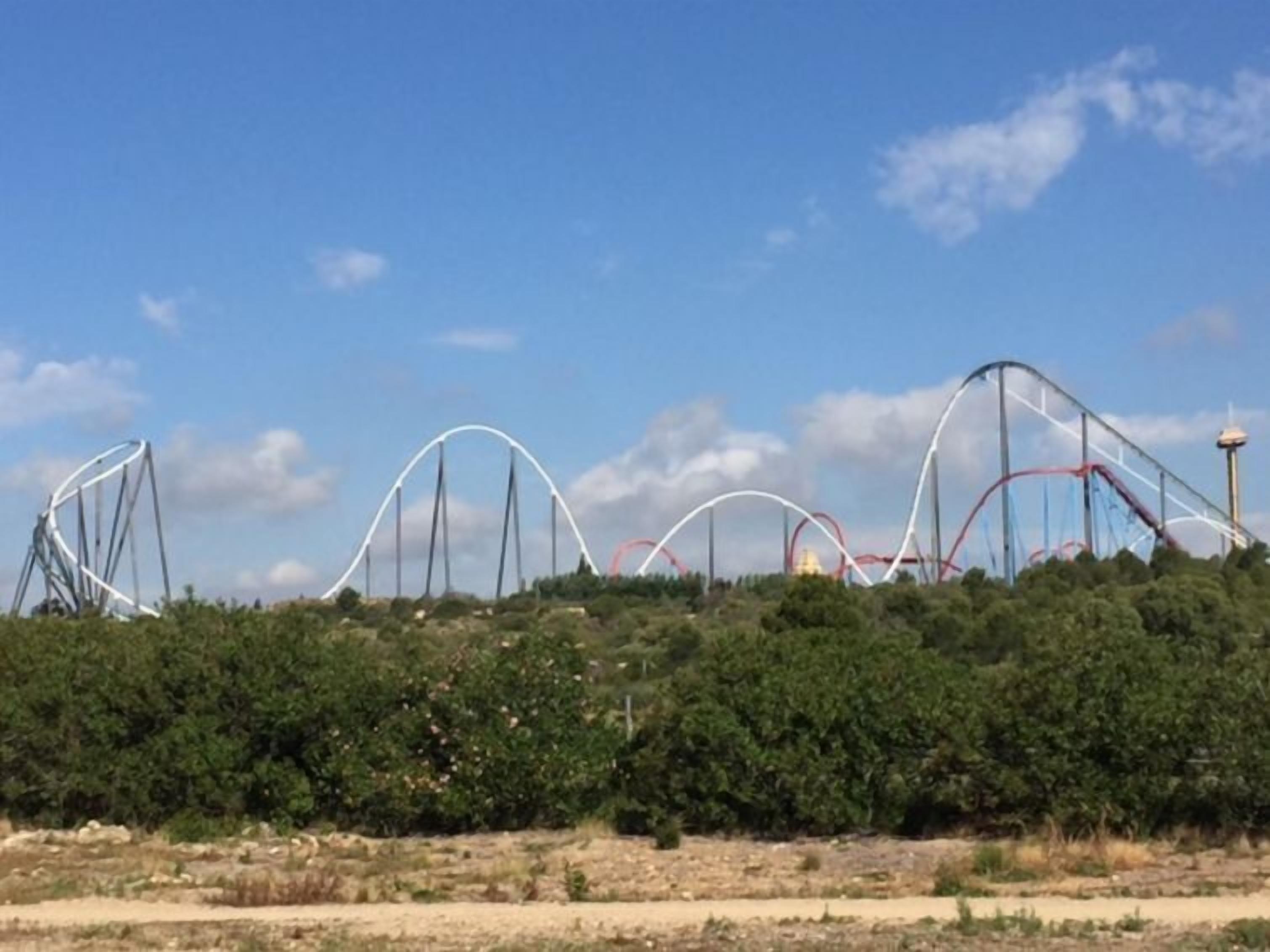 A roller coaster with multiple tracks and a clear sky.