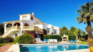 A large white villa with a swimming pool, outdoor seating, and a well-maintained garden. - Portichol by Interhome (Jávea)