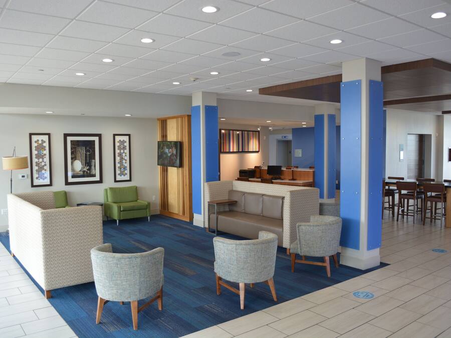 A lobby with seating areas, a reception desk, and a dining area.