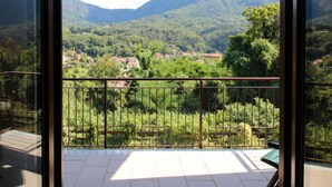 A balcony with a view of a mountainous landscape and a village below. - La Rocca by Interhome (Castelveccana)