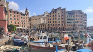 A marina with boats docked, surrounded by historic buildings. - Francesca by Interhome (Camogli)