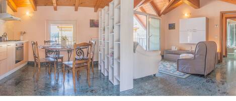 A spacious kitchen with wooden cabinets and a dining area with a table and chairs.