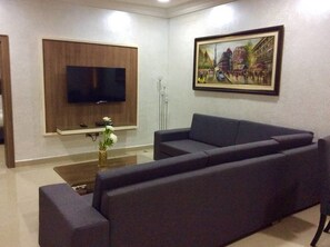 Executive Suite, 1 Queen Bed | Living area | 55-inch LCD TV with satellite channels, TV, iPod dock - Phoenicia Suites (Abuja)