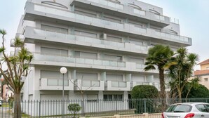 A multi-story building with balconies, a flat roof, and a gated entrance. - Jetée des Marins by Interhome (Arcachon)
