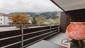A balcony with a view of a hilly landscape and a tree with autumn leaves. - Apartment Sepp by Interhome (Bad Hofgastein)