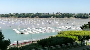 A marina with numerous boats docked, a clear sky, and a coastal town in the background. - Terrasses d'Emeraude by Interhome (Dinard)