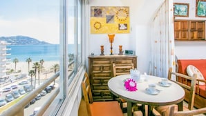 A balcony with a view of the sea and a table set with tea cups and saucers. - Roses Holiday Center by Interhome (Roses)
