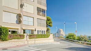 A modern building with balconies, a clear sky, and a mountain in the background. - Apartment Zeus by Interhome (Calpe/Calp)