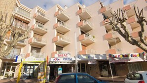 A multi-story building with balconies, a pharmacy, and a café. - Les Hesperides by Interhome (Cavalaire)