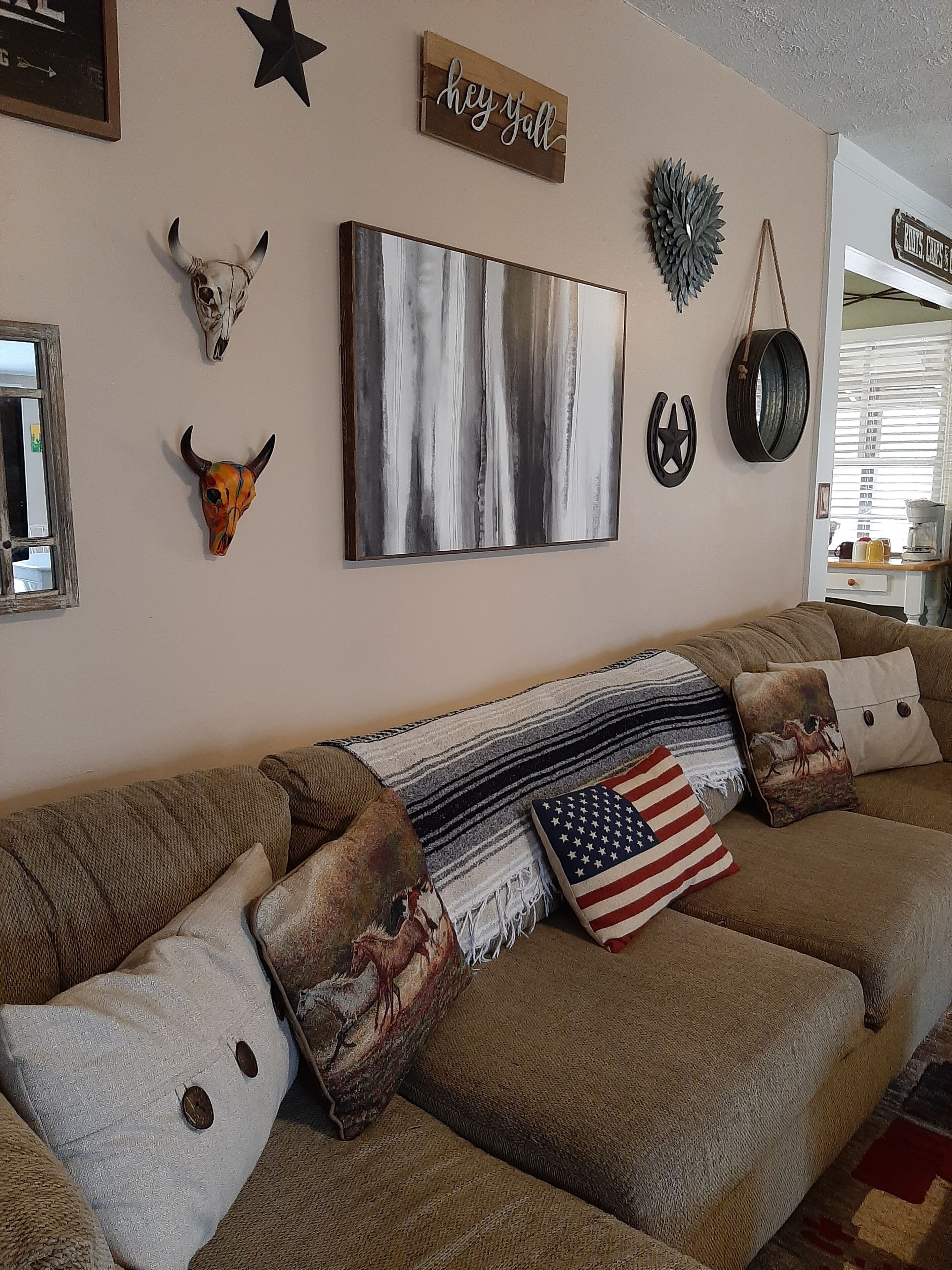 A cozy living room with a sofa adorned with various decorative pillows, including an American flag pillow.