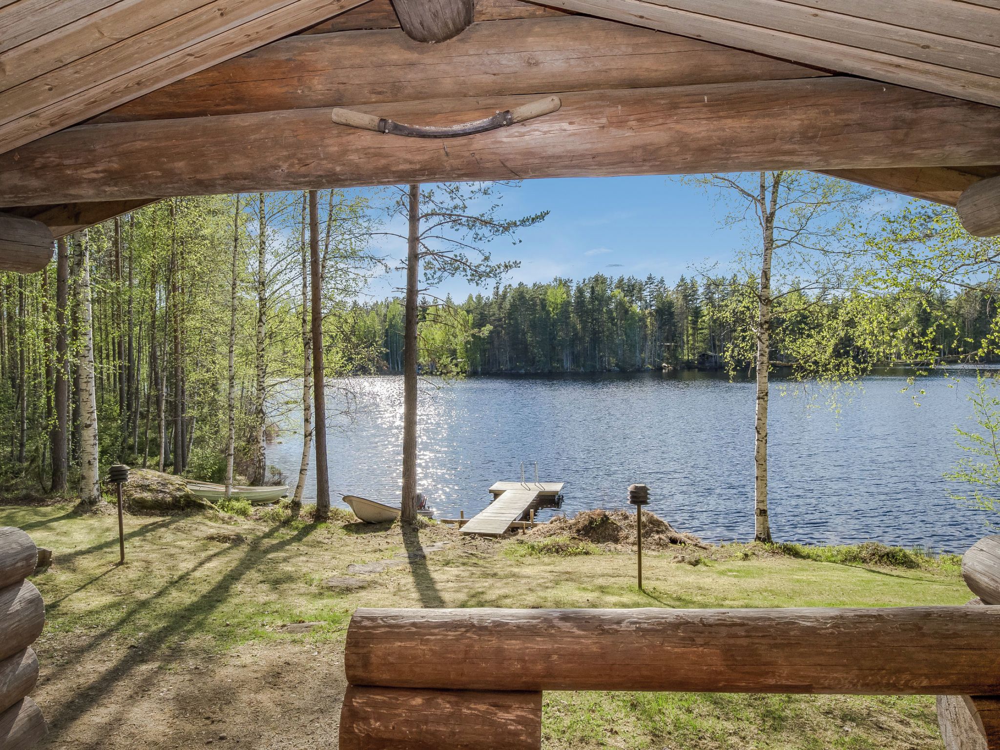 Una cabaña de madera con vista a un lago rodeado de árboles.