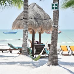 On the beach, white sand, sun-loungers, beach towels